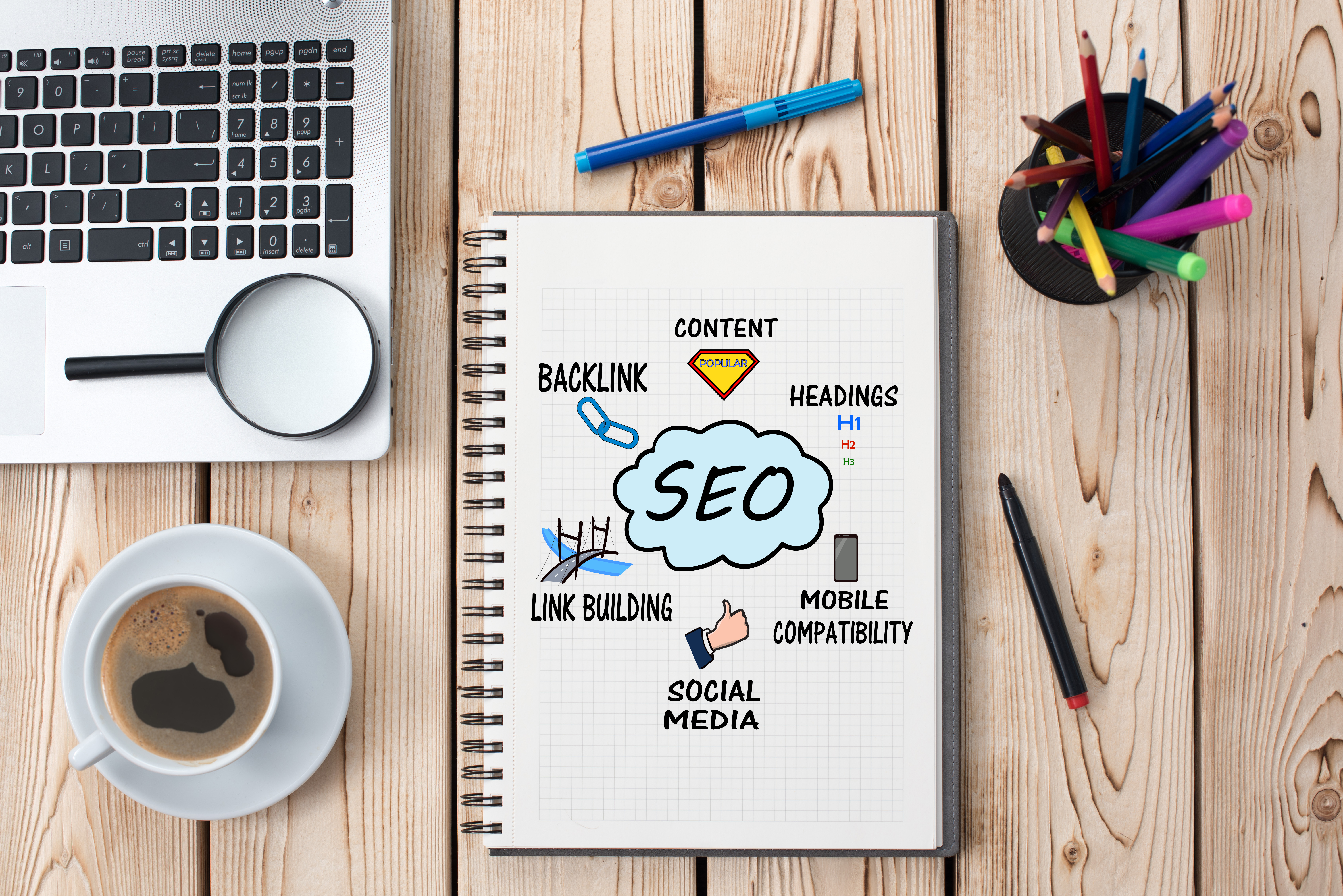 Office supplies surrounding SEO notepad