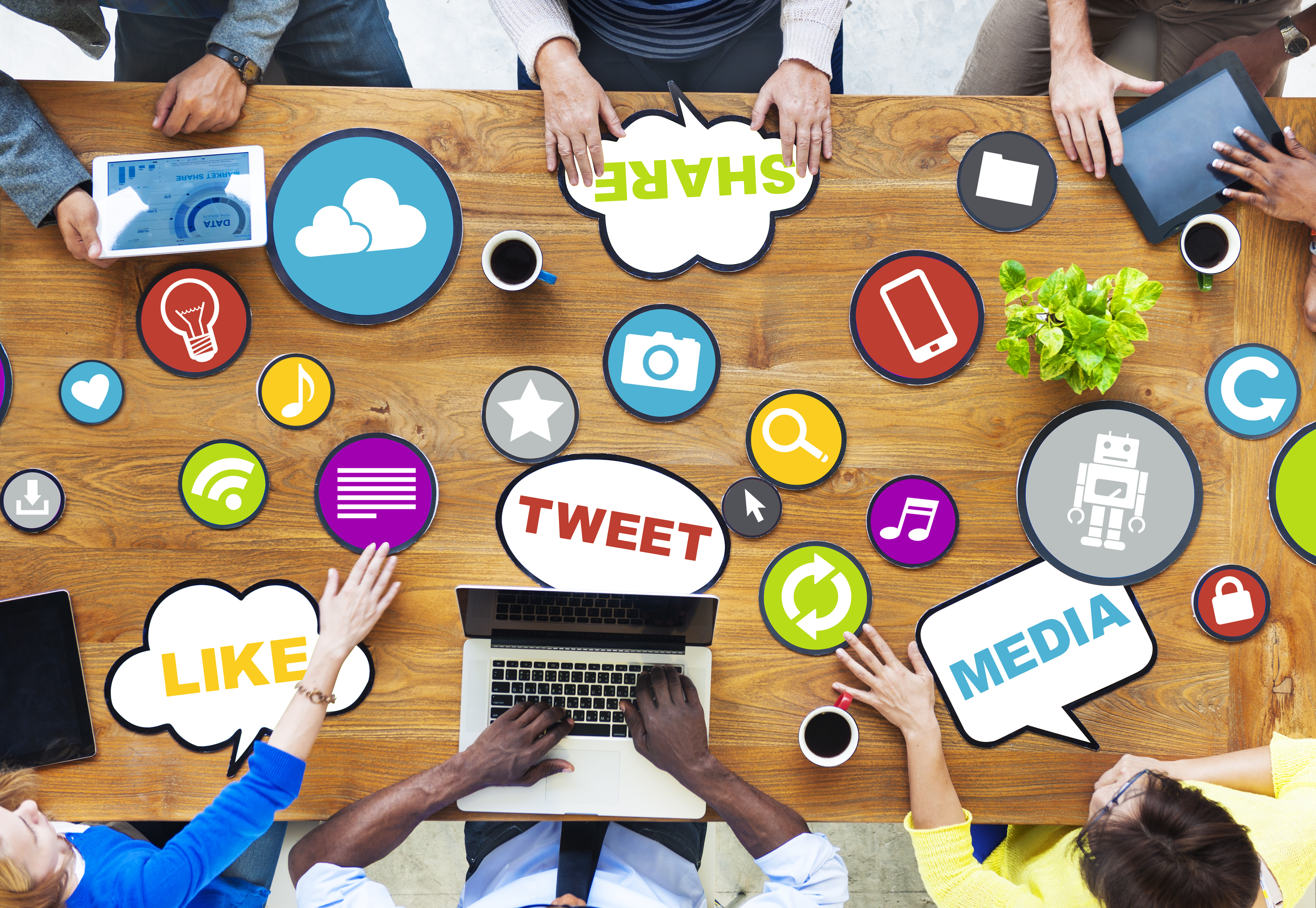 People sharing social media ideas at a table